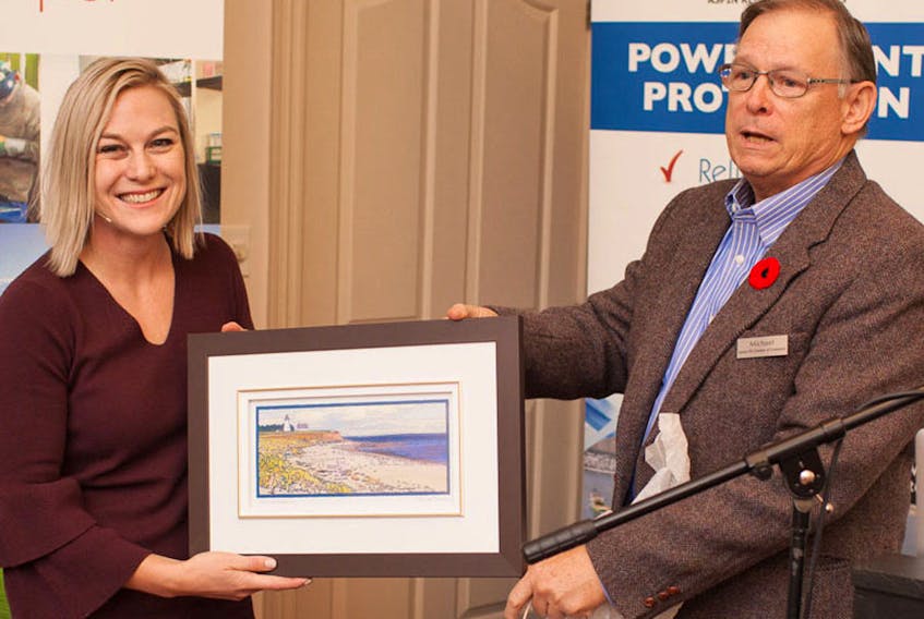 Nicole Verkindt, founder and CEO of OMX (market exchange) is presented with a gift from Michael Shumate, secretary of the Eastern P.E.I. Chamber of Commerce. Verkindt was the keynote speaker at the chamber’s recent conference. SUBMITTED PHOTO