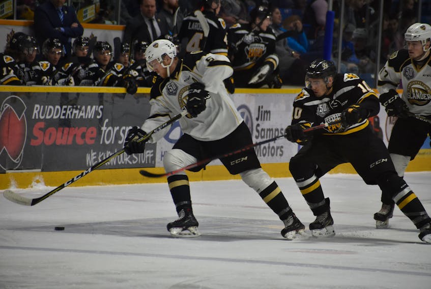 Charlottetown Islanders defenceman Hunter Drew, left, carries the puck as Cape Breton Screaming Eagles forward Shawn Boudrias looks to steal it from him during Quebec Major Junior Hockey League playoff action Tuesday at Centre 200.