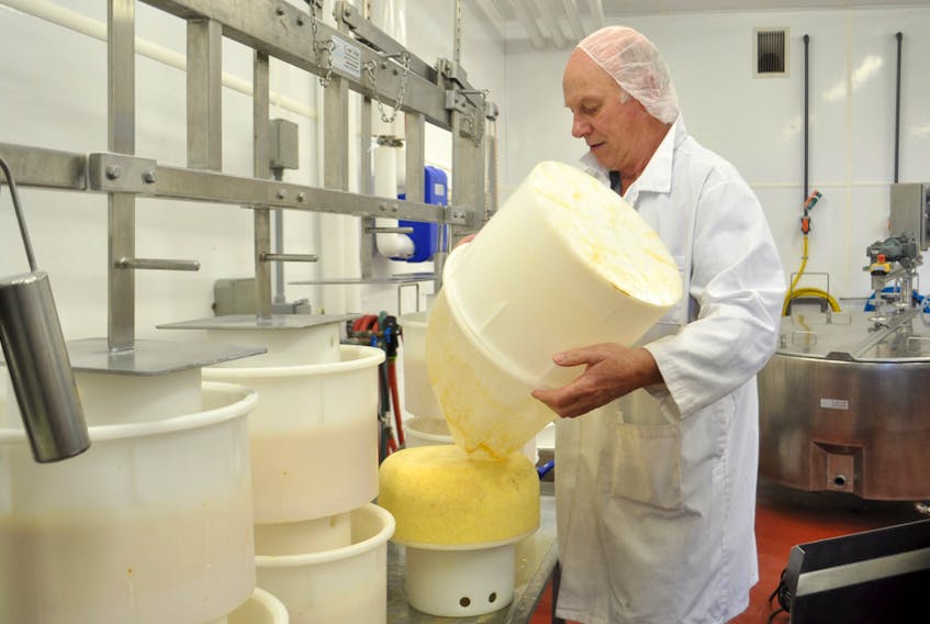 Frazer Hunter turns wheels of cheese in the Cheese House at Knoydart Farm in Antigonish County. Hunter made the move from traditional farming to organic farming about 15 years ago and hasn’t looked back.