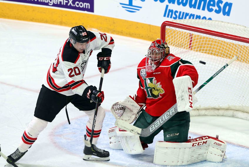 Quebec Remparts winger Andrew Coxhead tries to tip the puck past Halifax Mooseheads goalie Alexis Gravel during Saturday's QMJHL playoff game at the Scotiabank Centre.