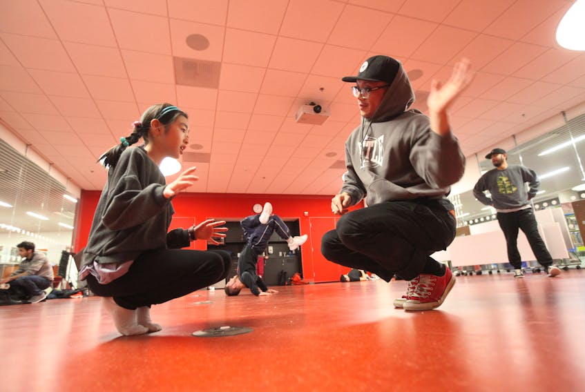 Lucy Hei, 10, tries to mirror instructor Nick Nguyen’s moves at a breakdancing drop-in at the Halifax Central Public Library Tuesday.