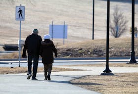 March 23, 2020–A elderly couple walk hand-in-hand along the sidewalk surrounding the Halifax Common Monday morning.