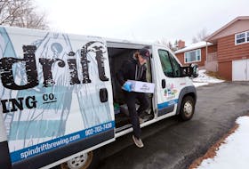 Noah Fournier from Spindrift Brewing makes a delivery to a home in Cole Harbour on March 27, 2020.