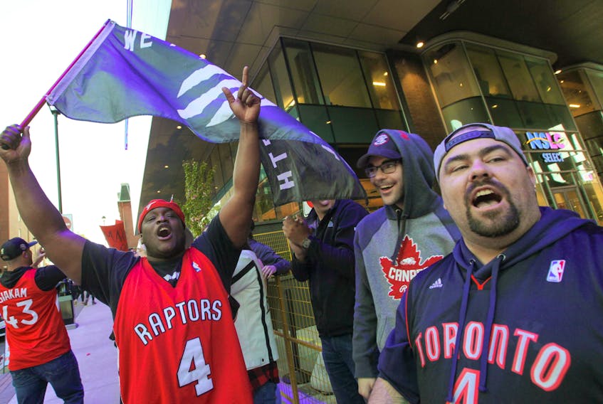 Toronto fan Michael Daniel waves the flag as he and 1,000 of his closest friends line up to get in Roger’s Square in Halifax to watch the Raptors battle the Golden State Warriors in game five of the NBA finals.
