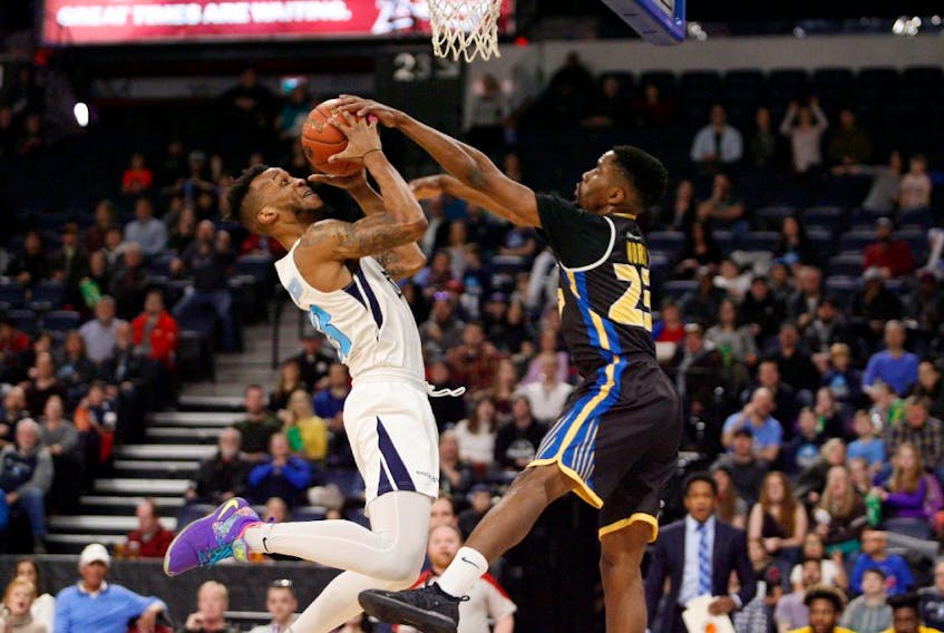 Saint John Riptide’s Jeremiah Mordi defends against the Halifax Hurricanes’ Joel Kindred during first-quarter action of an NBL Canada game at the Scotiabank Centre on Sunday. ERIC WYNNE