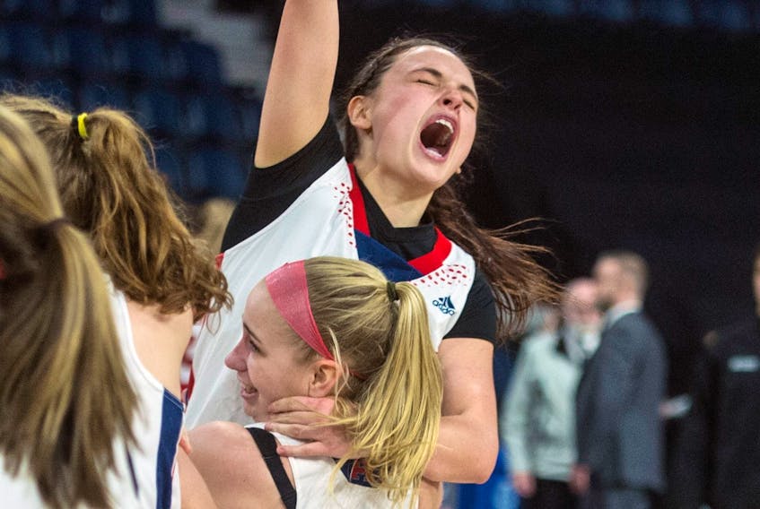 Acadia's Haley McDonald jumps into the arms of teammate Alyston Fulton as the Axewomen celebrate their 84-74 victory over the Memorial Sea-Hawks in the AUS Final 6 women’s basketball championship final at the Scotiabank Centre on March 3. RYAN TAPLIN - The Chronicle Herald