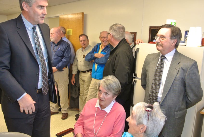 Premier Stephen McNeil speaks to Dr. Brian MacFarlane and Pugwash residents last April after announcing design tenders would be called that summer for a new health-care facility in the village. Residents voiced their concerns about the construction schedule and frequent ER closures at North Cumberland Memorial Hospital during a public meeting on Sunday.