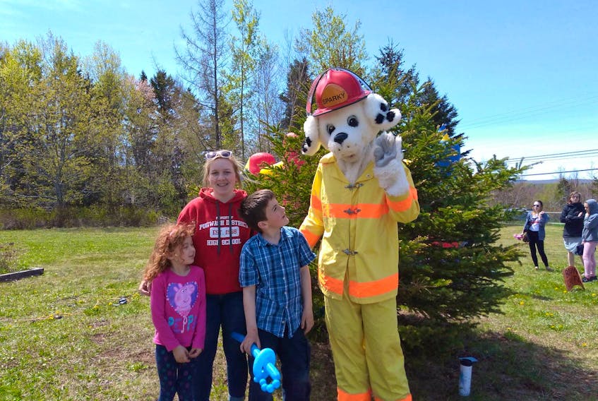 Abby Watson, Jessica Palmer, Ethan Watson and Sparky the Fire Dog enjoy the Community Fun Day located at the Wentworth Learning Centre.