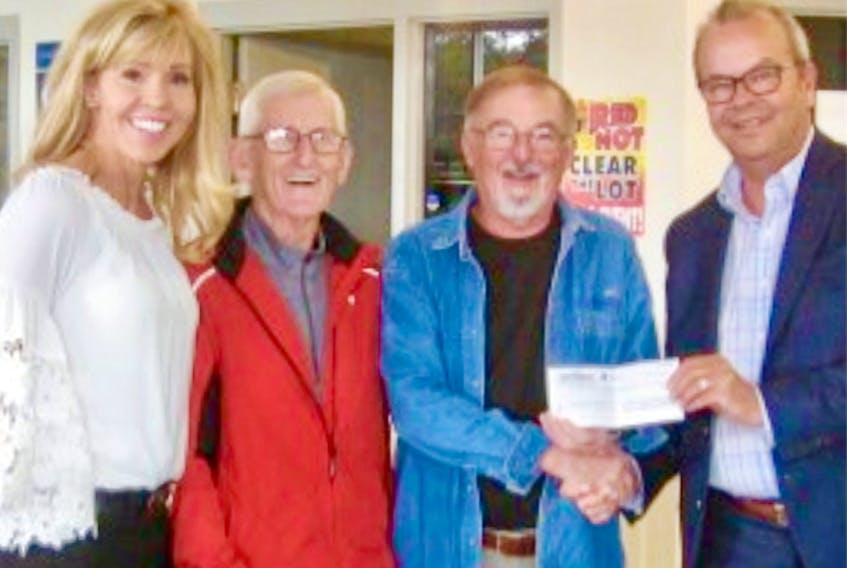 Pauline and Don Furlong of Tantramar Chevrolet Buick GMC Ltd. present a $5,000 donation to John van de Wiel and Mike Power of the Northumberland Community Curling Club.