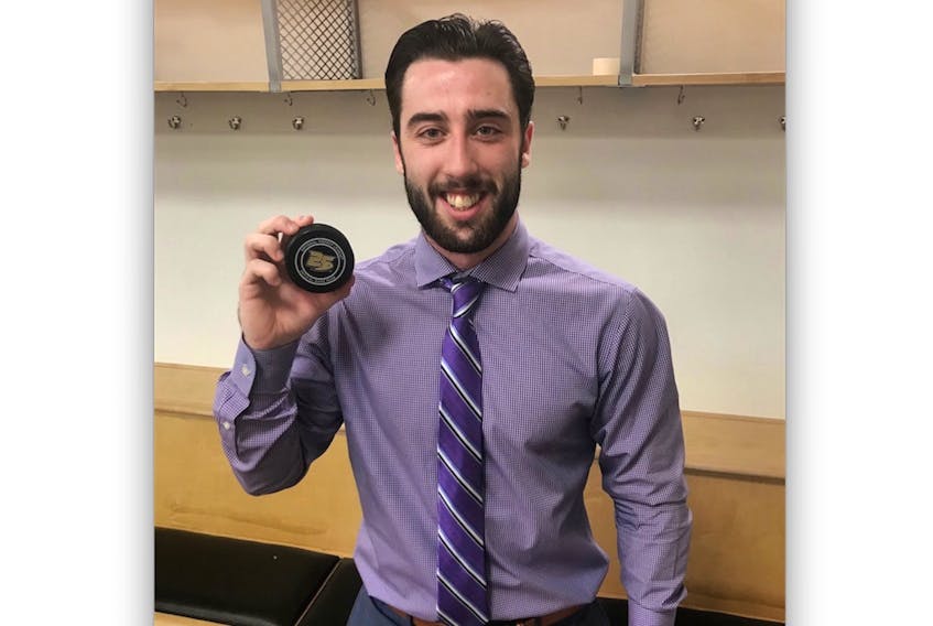 Carolina Hurricanes’ Clark Bishop holds up the puck from his first NHL goal, scored Friday night in Anaheim, Calif., in the Hurricanes’ 4-1 win over the Ducks. — nhl.com/hurricanes/Twitter