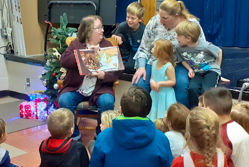 Wee Wana Sprague reads the Christmas story, Firefighter Night Before Christmas, following the three-lighting ceremony in Wentworth. Hope Bridgewater photo