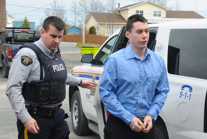 Mateo Brewer is shown being escorted to Harbour Grace Provincial Court on Friday, May 4.