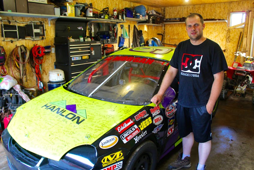 Andrew Morgan stands next to the Dodge Neon he started out with five years ago – the same car that he flew the checkered flag from on July 28.