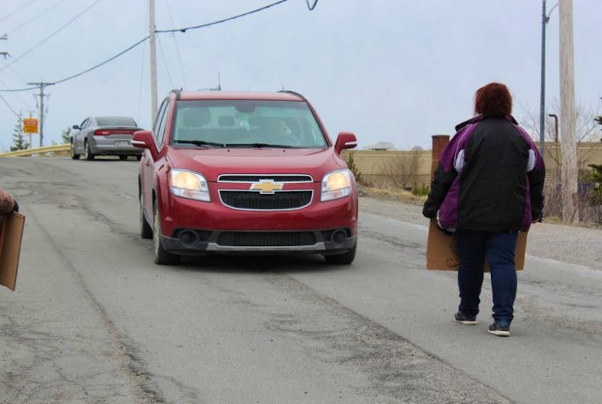 Tonya Somerton stands in front of an oncoming vehicle during the protest.