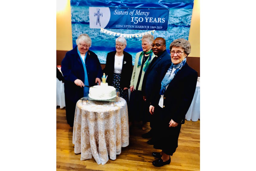 On hand for the cutting of the celebration cake marking 150 years were, from left, Sister Elizabeth Davis, Sister Ruth Beresford, Sister Ellen Marie Sullivan, Father Thomas Offong and Sister Geraldine Mason.