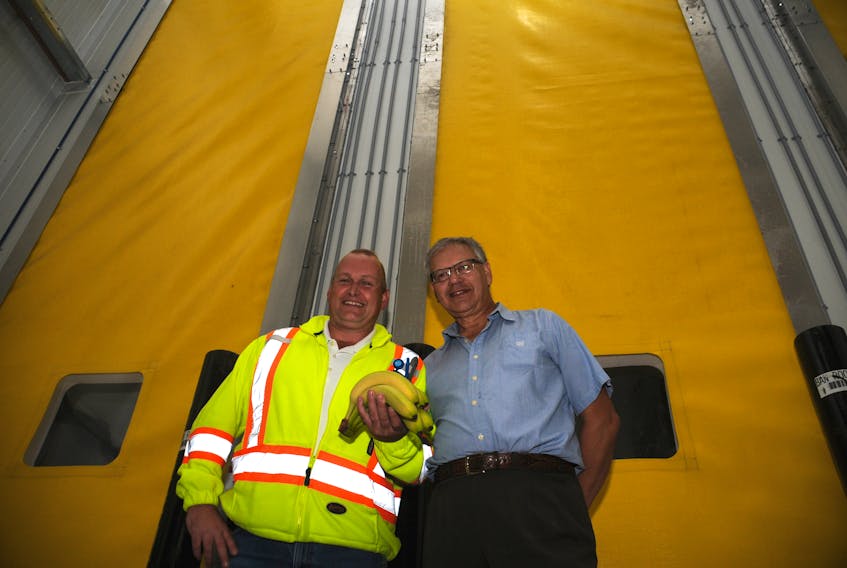 From the left, Atlantic Grocery Distributors quality assurance manager Bill Hunt and company president and CEO Dave Powell stand in front of the new banana ripening rooms.