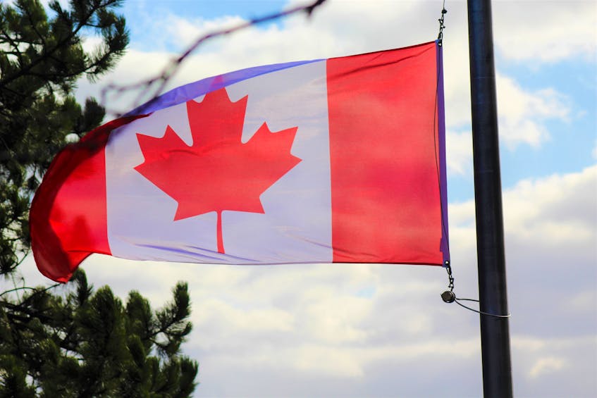 Strong November winds kept the Canadian flag on full display during the ceremony.