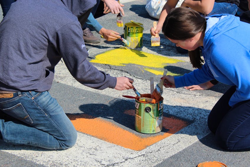 Students gathered outside Baccalieu Collegiate on Thursday morning, May 17 to paint a second crosswalk with rainbow colours.