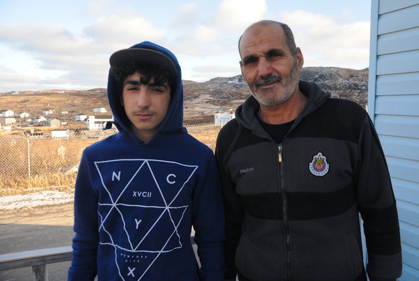 Mahmaud AlTaani, left, and his father Mahmaed are adjusting to life in Grates Cove, Newfoundland and Labrador. The AlTaani family fled Syria almost six years ago and arrived in the province last August.
