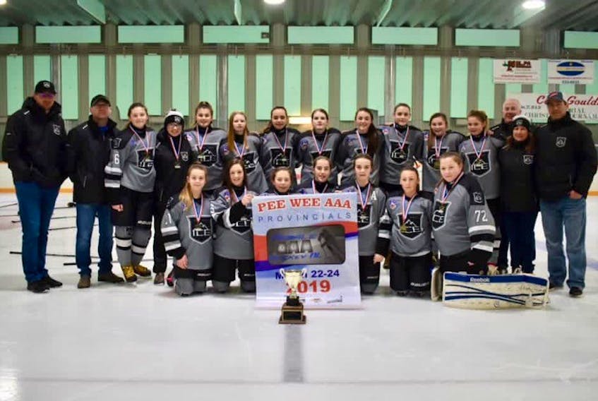 Players and coaches from the Tri Pen Ice Pee Wee AAA girls team that claimed a provincial championship in Glovertown.