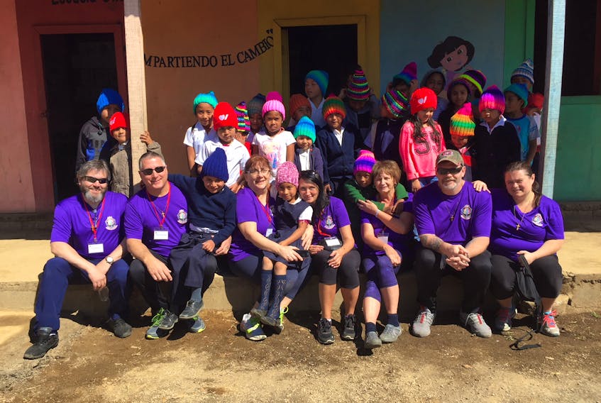 The travellers from Newfoundland at a small public school in Guatemala. Here they gave out school supplies and knitted hats from family back home.