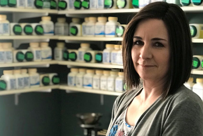 Anne-Marie McCully in front of her herbal pharmacy. McCully's pharmacy includes hundreds of different herbs, which can either be taken in capsule or tea form. - ANNE-MARIE McCULLY PHOTO