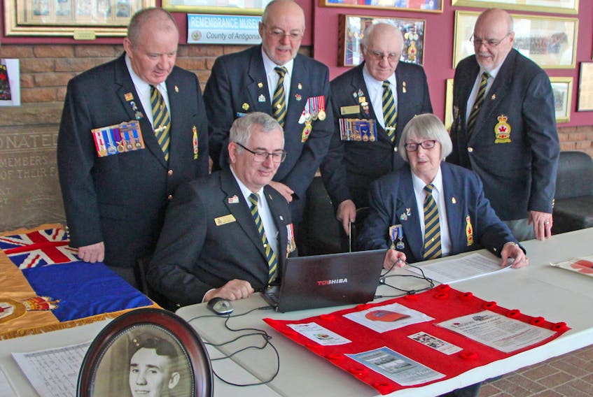Royal Canadian Legion Arras Branch 59 in Antigonish has launched a wartime photo collection initiative that will be added to the museum at its location in the East Coast Credit Union Enterprise Centre on St. Ninian Street. Here, branch president James Matheson (left, seated), Mary MacDonald, Gordon MacDonald (back, left), John MacDonald, J.P. MacEachern and Bill Detweiler look over the first contributions to the project. Corey LeBlanc