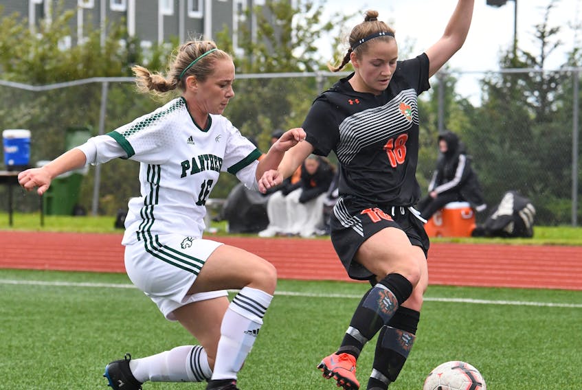 Antigonish native Rebecca Lambke of the Cape Breton Capers shields the ball from Olivia Cummings of the UPEI Panthers in Atlantic University Sport (AUS) action this season. CONTRIBUTED BY VAUGHAN MERCHANT