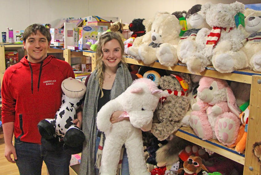 Scott MacInnis and Katelynn D'Albertanson made a recent visit to the Monsignor Hugh MacPherson Council of the Knights of Columbus toy drive 'toy house' at Antigonish Market. The second-year business students are part of Christmas Joy at St. F.X., an effort to have students make contributions to the annual effort. Corey LeBlanc