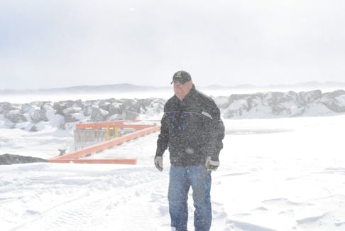 Wallace Gillard steps out to the new Gillard’s Cove wharf on a windy and snowy morning.