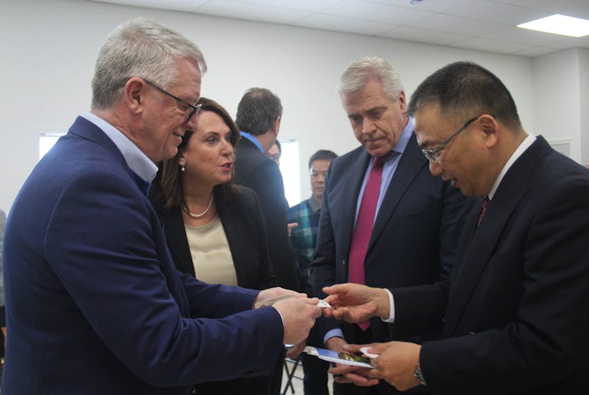 Ed Moriartiy, left, executive director of the Mining Industry NL, exchanges contact information with Huang Chongbiao, vice president of China Minmetals, right, while discussing the province’s mining potential with Natural Resources Minister Siobhan Coady and Premier Dwight Ball.