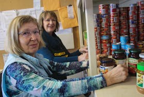 After the loss of the Community Food Sharing Association’s warehouse in St. John’s late last month, central Newfoundland food banks appear to be holding their own when it comes to keeping supplies on hand. Pictured, volunteers Val Tweedie, front, and Roberta Drover stock shelves at the Gander Food Bank.