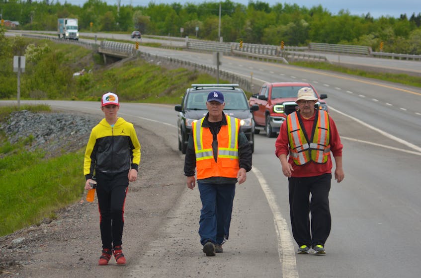 The trio of, from the left, Benjamin Blake, George Hart and Bill Mayne finish the last couple of kilometres of the walk to Grand Falls-Windsor from Badger on Monday. Hart and Mayne started the walk earlier around 6 a.m. in Badger and were joined by Blake just outside their destination community.