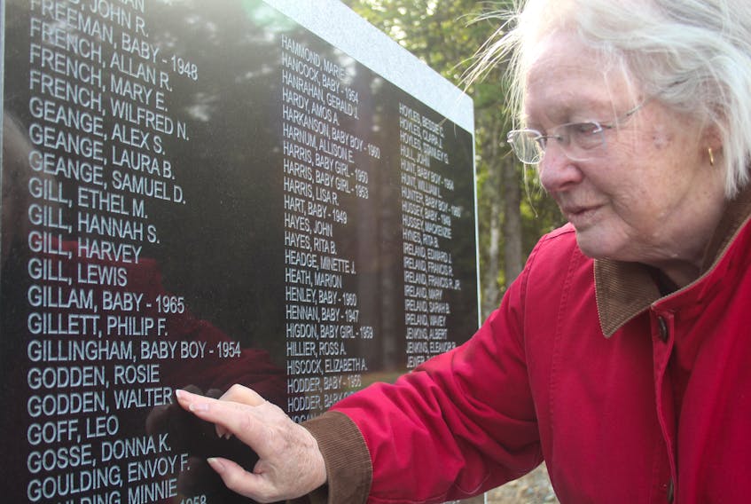Clarice Goodyear, who assisted the Gander Lions Club with its purchase of the cenotaph, was on hand for the mounting of the monument Sept. 11. She has lived in Gander since 1956 and recognizes many of the names. Pictured, Goodyear points to Walter Godden, a dear friend of her late husband Joe. The two developed their friendship through the Lions Club.