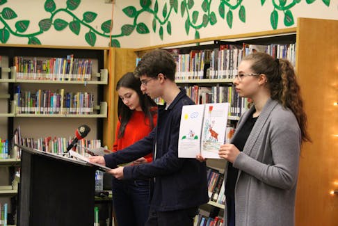 From left, former students ShyAnna Mercer, Mark Roberts, and Leah Roberts present “The Mammoth Bakeapple” at the Harmsworth Library in Grand Falls-Windsor Feb. 18.