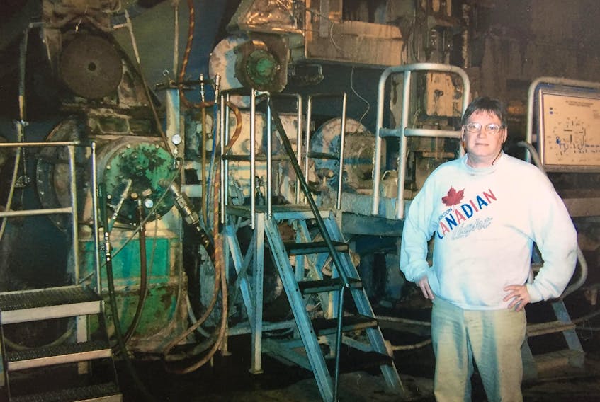 Joe Tremblett worked at the AbitibiBowater paper mill from 1972 to its closure in 2009. Here he stands next to the machine he spent so much of his life working on the day of the closure.