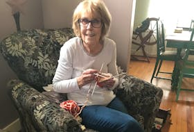Judy Canton of Amherst sets her attention on a new pair of mittens. CONTRIBUTED