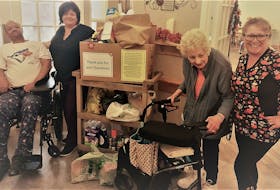 Residents, volunteers and staff at The Ivy Meadows take opportunities to engage with, and give back to, the greater community. Randy Williams, Jean Hatcher, Rae Davis and Martha Doubleday display the fruits of their food drive to help a local food bank. - Michelle Ellis