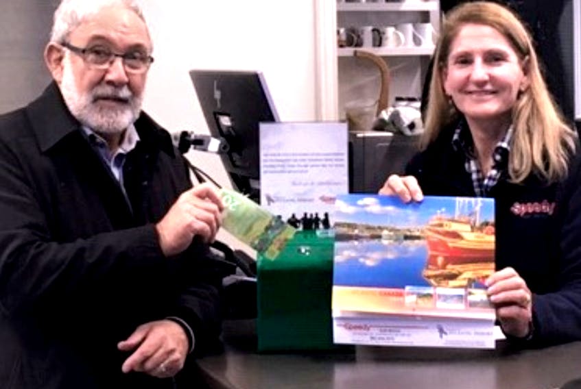 Maurice Muise, co-founder of the Society of Atlantic Heroes, purchases, by donation, a calendar to raise money for Atlantic House in HRM Speedy Auto, Tacoma Drive, Dartmouth, where he – and all veterans and first responders – get a discount.