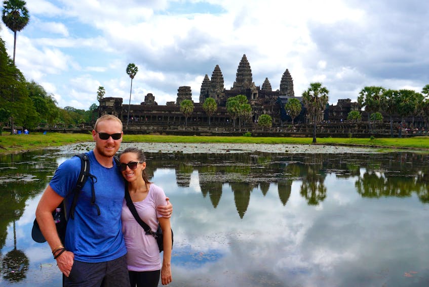 Steven (left) and Jess Trickett pose for a picture outside Angkor Wat in Siem Reap, northern Cambodia. The pair took a year off from their North American routine to travel the world.