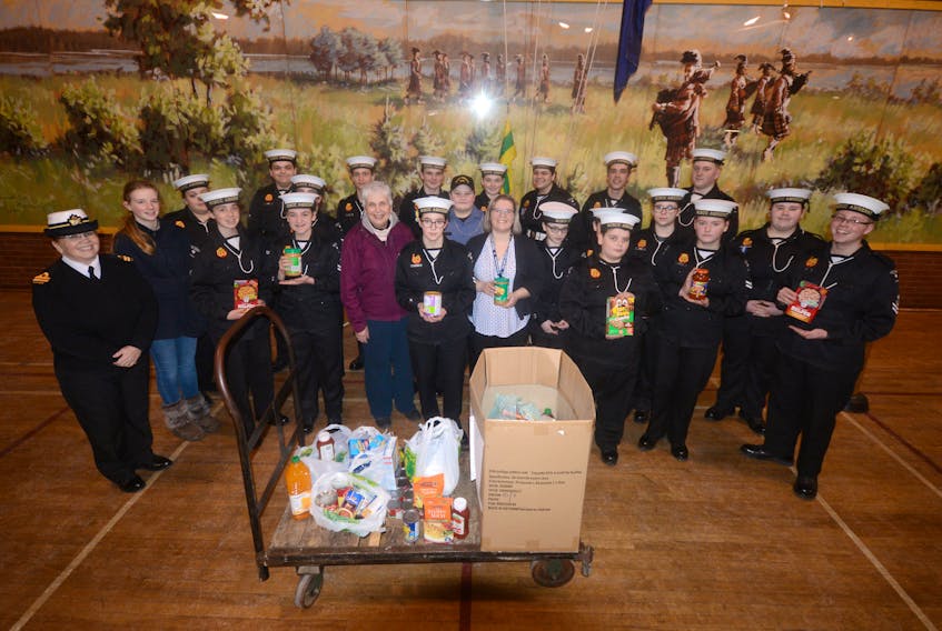 Members of the 258 Royal Canadian Sea Cadet Corps Amherst, along with Charlotte Ross of the Amherst Food Bank, gather around the more than 100 pounds of food the cadets collected for the Amherst Food Bank. The Cadets made the presentation to Ross on March 5 at the Colonel James Layton Ralston Armoury in Amherst.