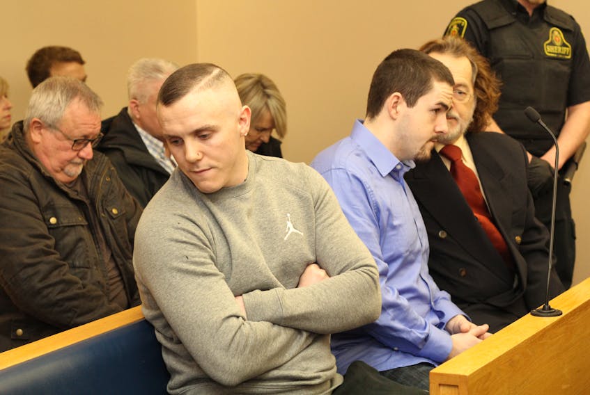 Calvin Kenny (left) leans away as Chesley Lucas speaks with his lawyer Bob Buckingham. The pair were sentenced 12 years and six months in prison in relation to the stabbing death of Steven Miller in 2016.