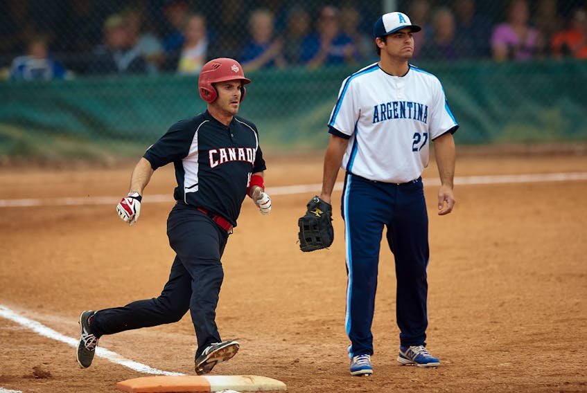 Jeff Ellsworth makes the turn around first base during an international softball competition in 2015.