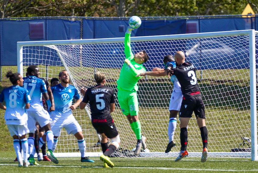 HFX Wanderers FC keeper Christian Oxner punches away a shot by Atletico Ottawa during   CPL Island Games action on Sunday. Oxner made five saves for the clean sheet in a 2-0 win. Chant Photography