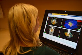 A technician reviews scans from the CT machine so she can map out where the areas to be given radiation treatment. This is important because the radiation should only hit, as much as possible, the areas that area affected by cancer and not others.