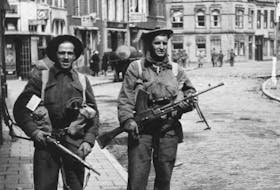 Cpl. Howie Dawe (left) from Springhill, and Pte. Earl Wilson (r) from Whitney Pier, from A Company, Cape Breton Highlanders, on a street in Delfzijl, Holland, May 1, 1945. Courtesy of the Ties Groenewold Collection, Holland, 2015.