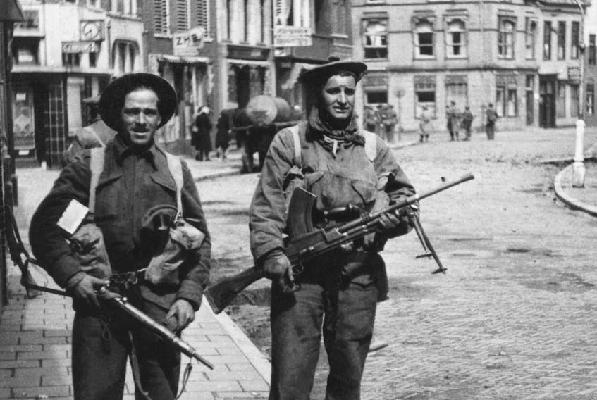 Cpl. Howie Dawe (left) from Springhill, and Pte. Earl Wilson (r) from Whitney Pier, from A Company, Cape Breton Highlanders, on a street in Delfzijl, Holland, May 1, 1945. Courtesy of the Ties Groenewold Collection, Holland, 2015.