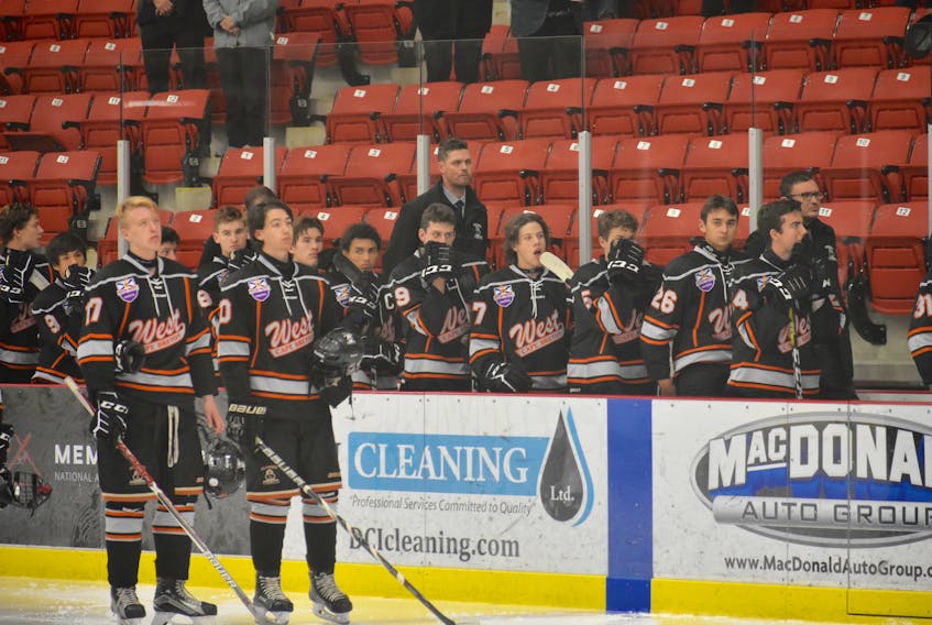 Members of the Cape Breton West Islanders stand for the national anthem during a game against the Cape Breton Unionized Tradesmen earlier this season. The Islanders are currently in the playoffs against the Valley Wildcats and lead the series 2-1.
