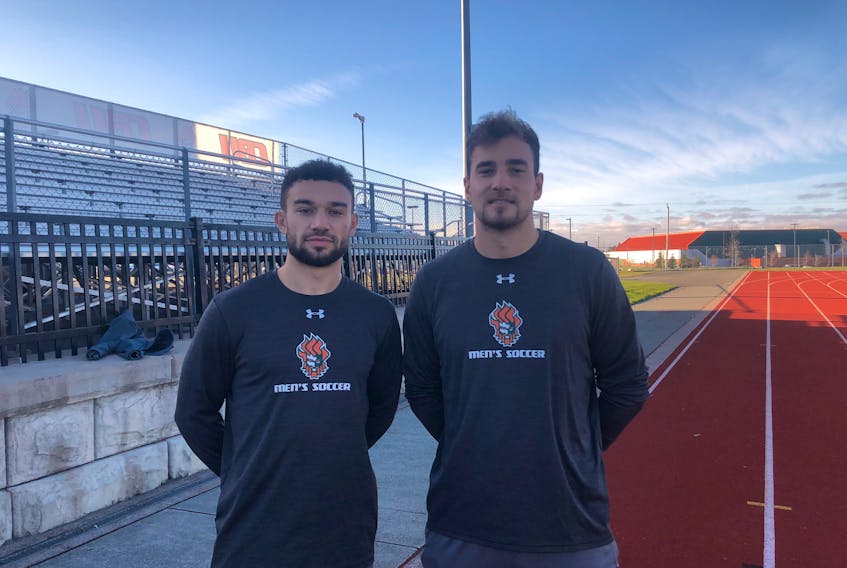 Cape Breton Capers players Marcus Campanile, left, and Peter Schaale at the Cape Breton Health Recreation Complex turf field on Tuesday. The fourth-year players are expected to play in their final Atlantic University Sport championship tournament this week.