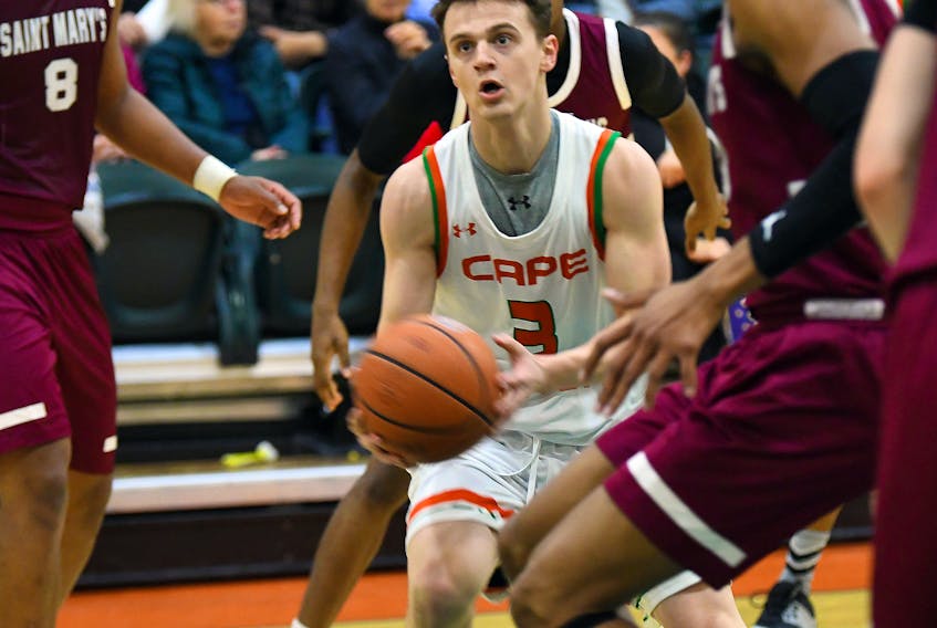 Cape Breton’s Jason Callaghan is a study in concentration as he eyes the hoop while surrounded by a pack of Huskies during the Capers’ 82-61 win over Saint Mary’s on Saturday at CBU’s Sullivan Fieldhouse on Saturday. The former Sydney Academy Wildcat scored 13 points in the victory.